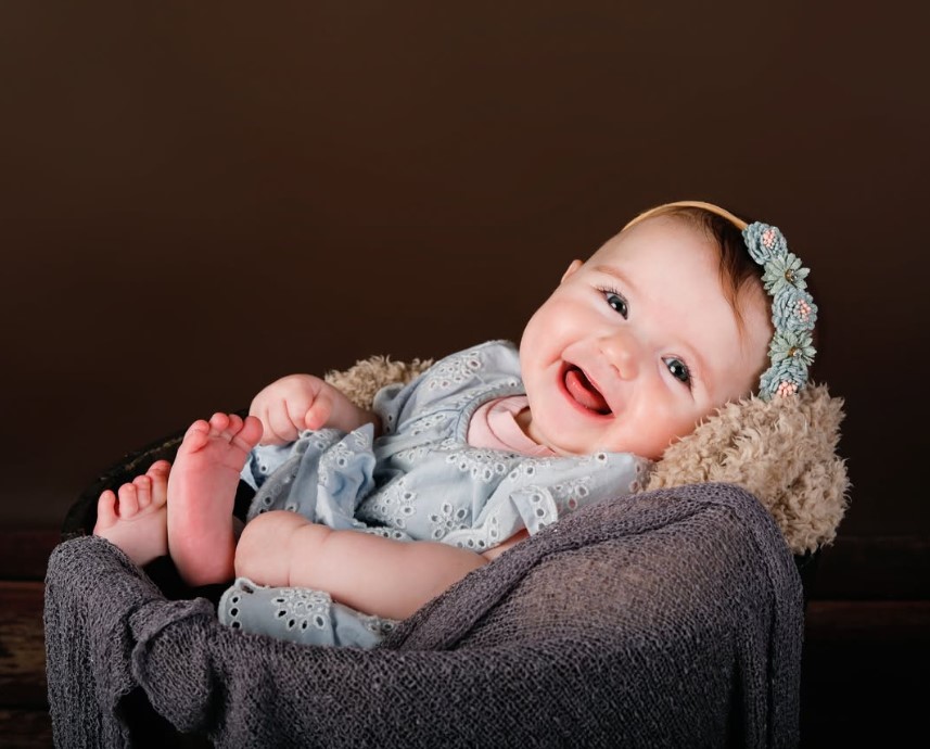 Giggling newborn baby portrait