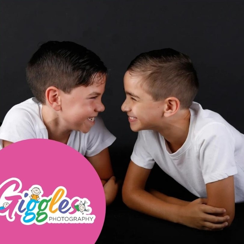 Two brothers laughing together in a sibling portrait